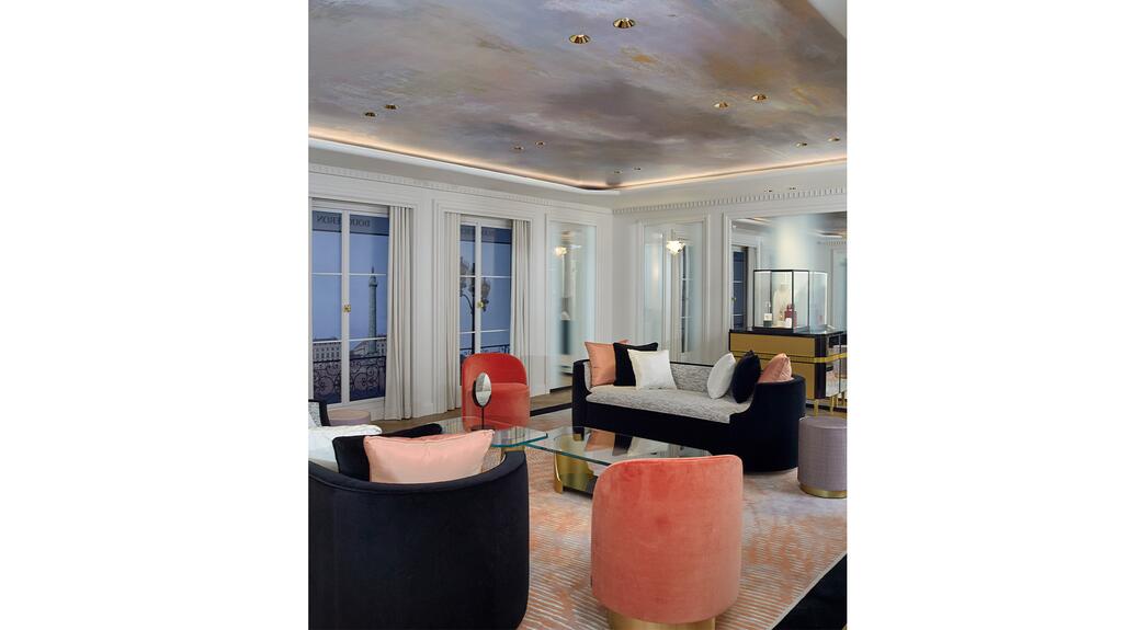Boucheron’s VIP room is a re-creation of the company’s private apartment in Paris, 26 V, with could-patterned wallpaper on the ceiling, windows with digital animations displaying Place Vendôme, a white fireplace, and furnished with a Pierre Chareau sofa from 1923. Boucheron’s VIP Room Inside NY Store